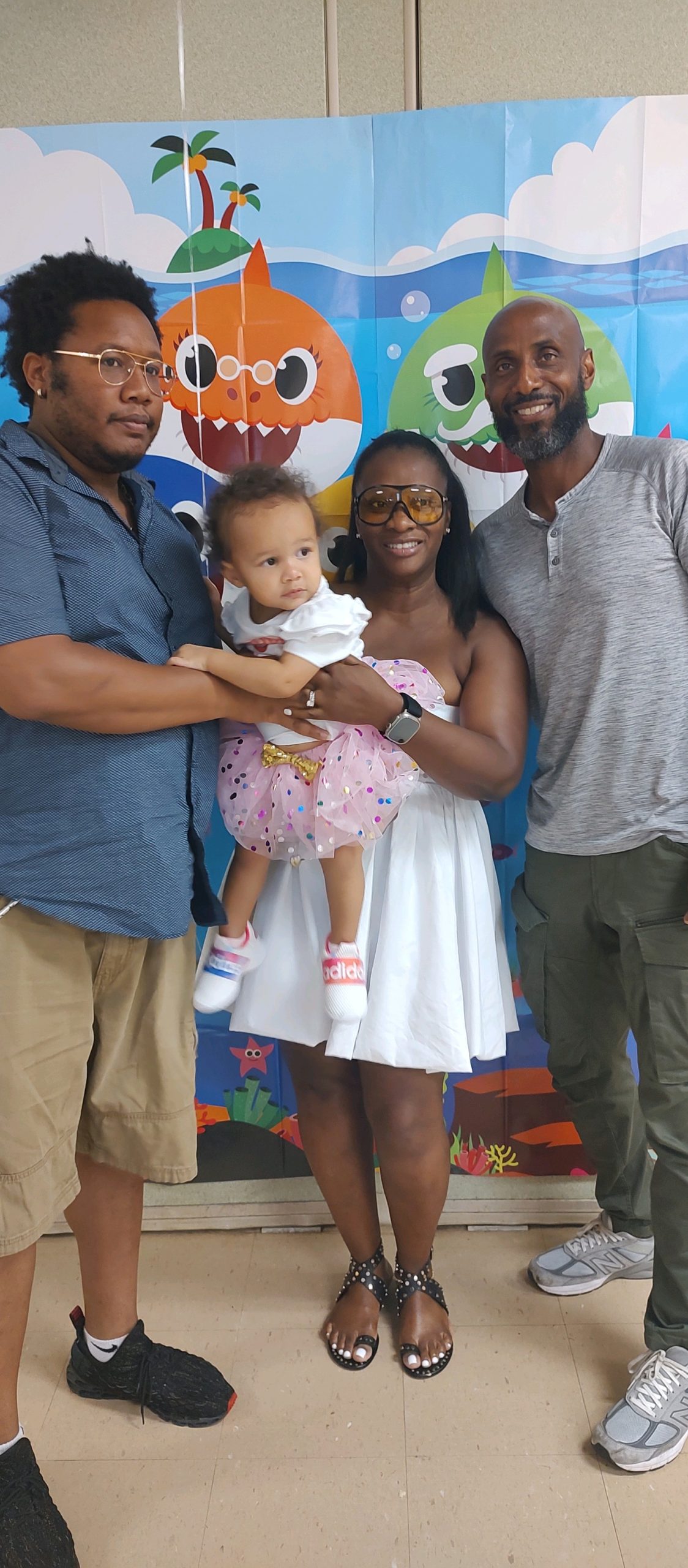 Akilah with her granddaughter, husband, and eldest son.