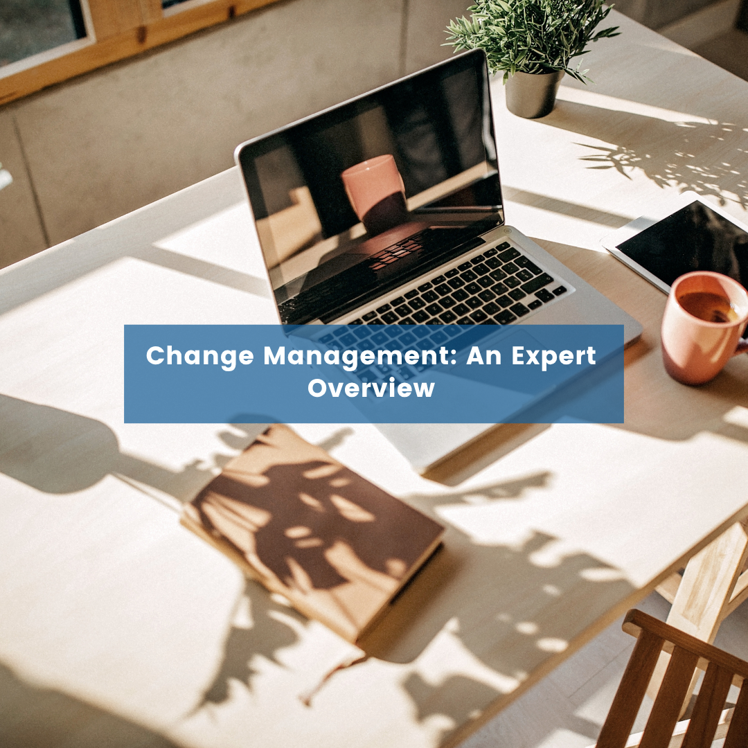 Change Management An Expert Overview Blog Post Cover a desk with a laptop and papers