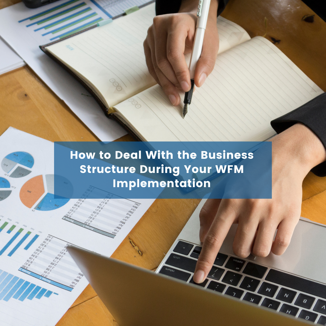 How to Deal With the Business Structure During Your WFM Implementation Blog Post Cover (1) person writing in a notebook and pointing at a laptop